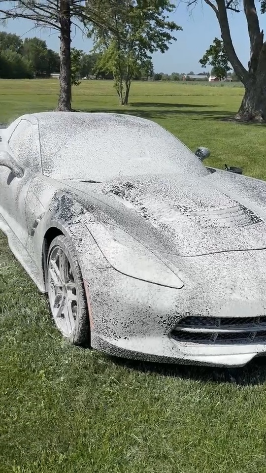 Corvette front end covered in foam during the wash process